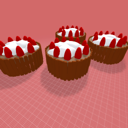 Two Kitkat cakes with cream and strawberries