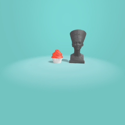 Some one puts a cupcake next to a famous statue