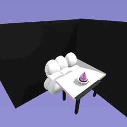 The sofa on the floor and the cupcake on the table.